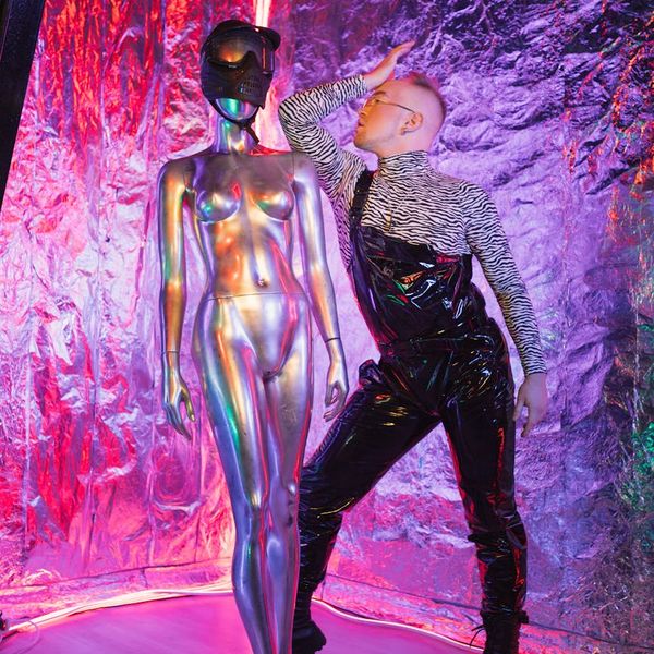 Silhouette of a man in a balanced pose against a light purple background.